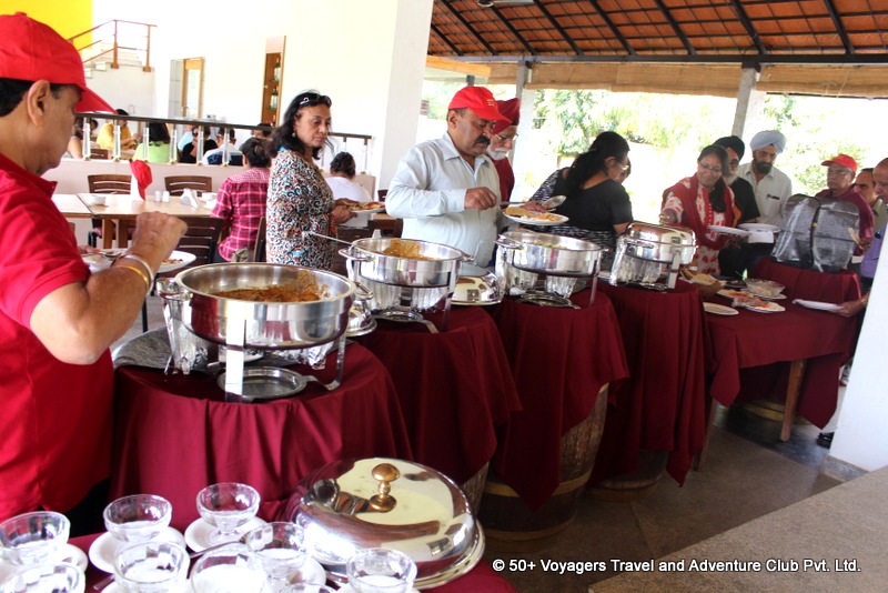 senior citizens enjoying indian cuisine with wine